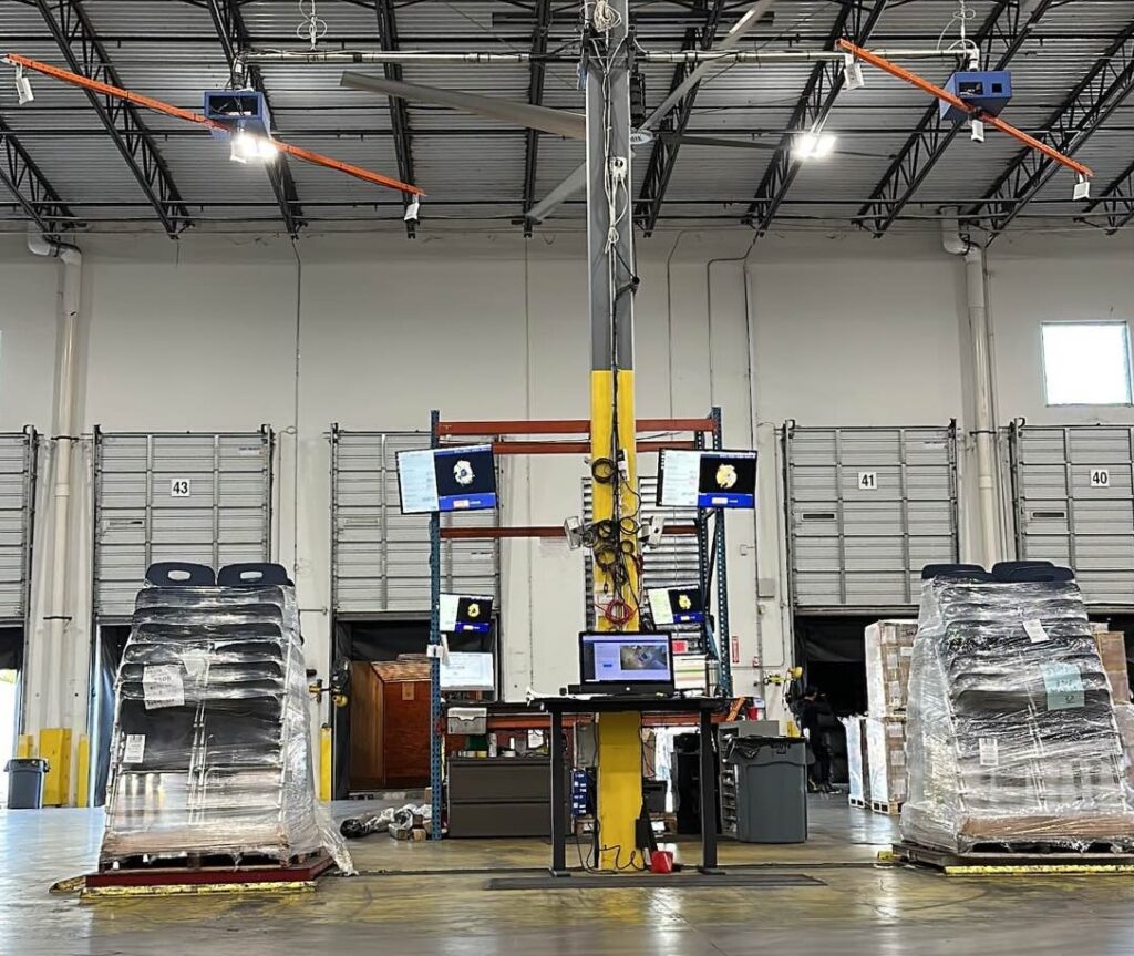 Two Cargo Spectre dimensioner systems set up side by side in a warehouse
