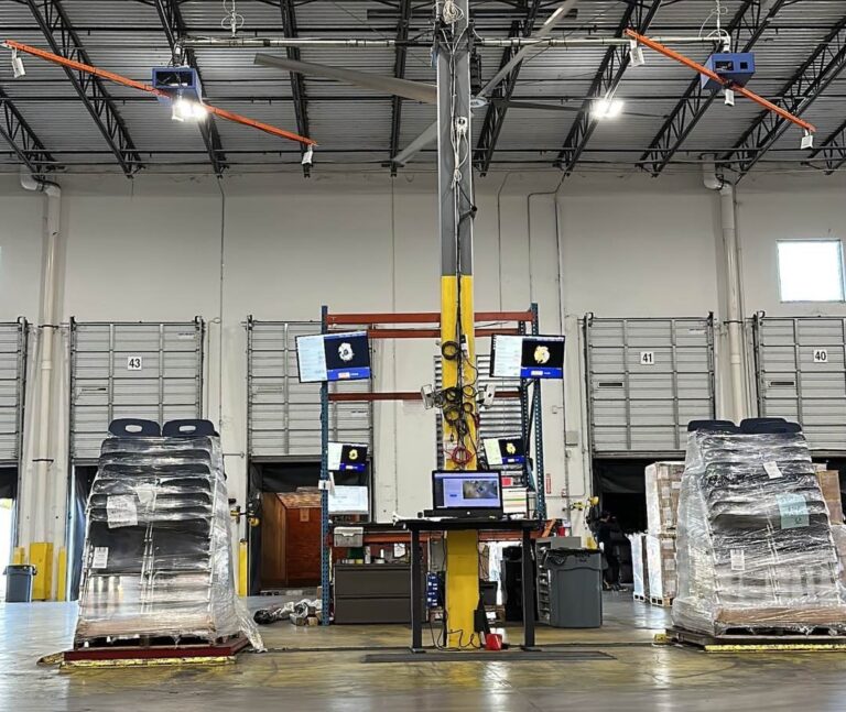 Two Cargo Spectre dimensioner systems set up side by side in a warehouse